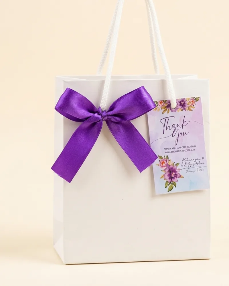 Elegant white return gift bag with purple ribbon bow and thank you tag Chennai