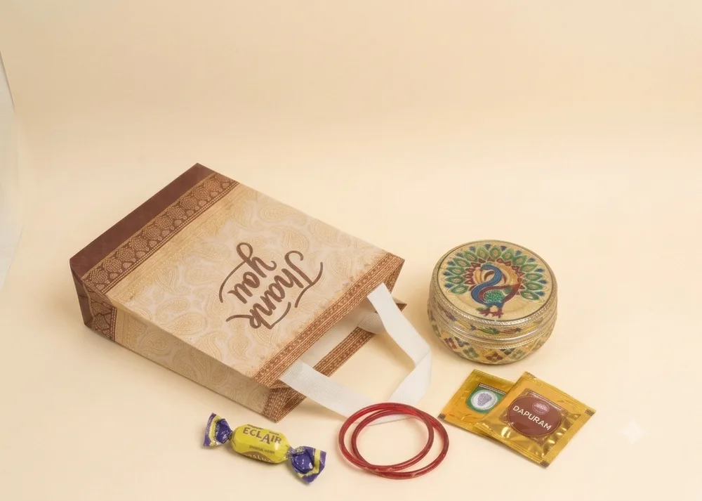 Paisley print thank you return gift bag with peacock enamel box and pooja items for weddings in Chennai